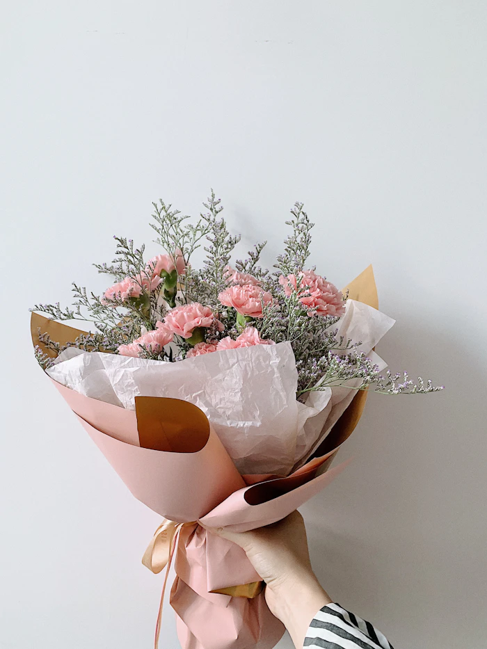 A small hand-tied posy wrapped in paper