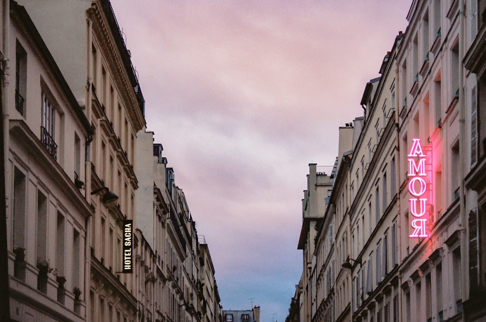 people walking on street between high rise buildings during daytime, the city of love paris