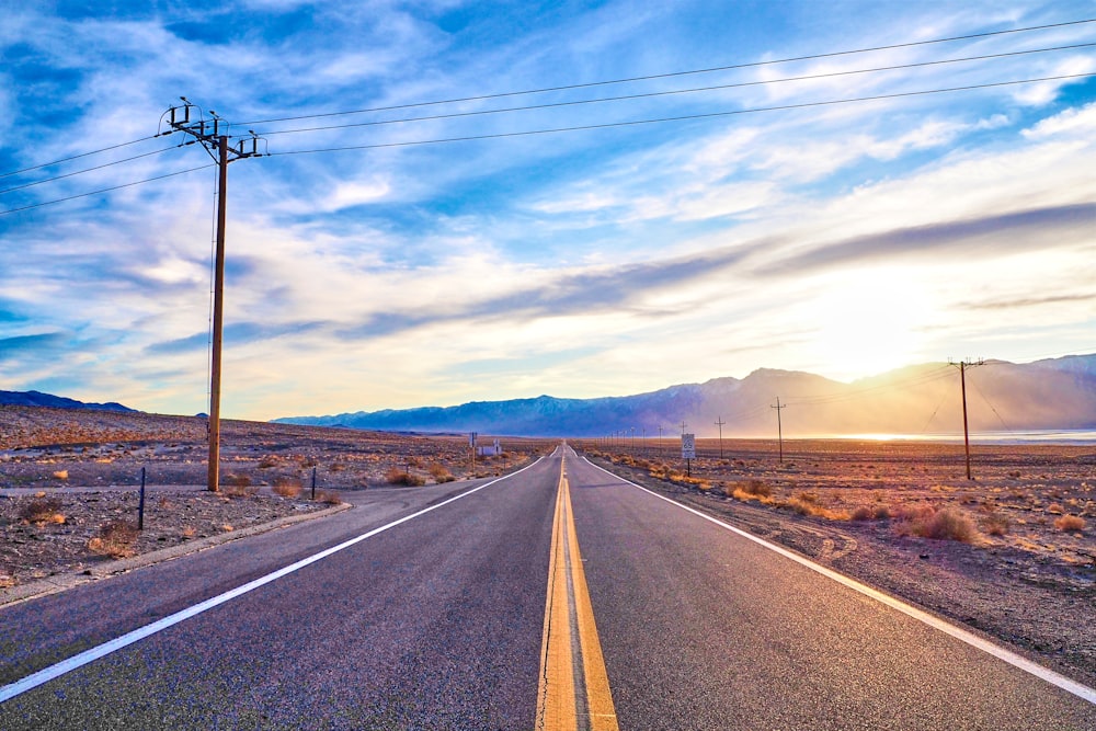 gray concrete road under blue sky during daytime