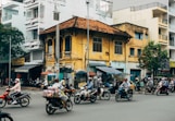 motorcycle parked beside brown concrete building during daytime