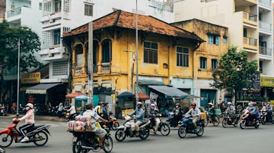 motorcycle parked beside brown concrete building during daytime