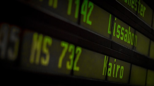A vibrant airport departure board showing discounted flight destinations.