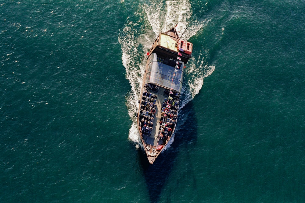 brown and black boat on body of water during daytime