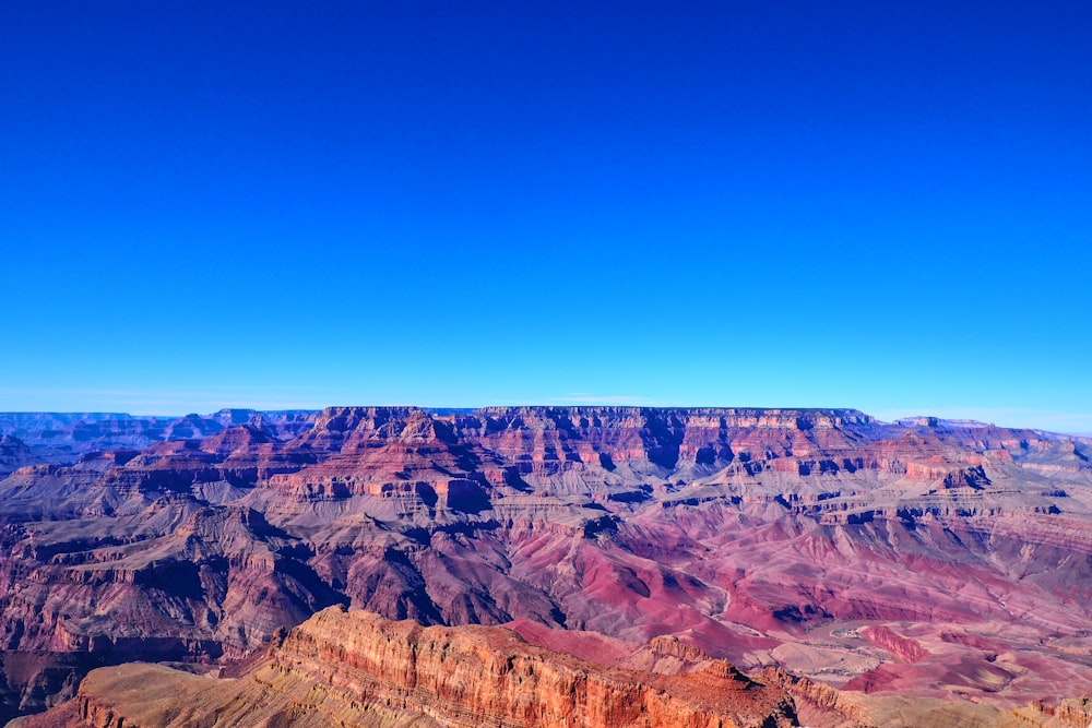 brown rocky mountain under blue sky during daytime