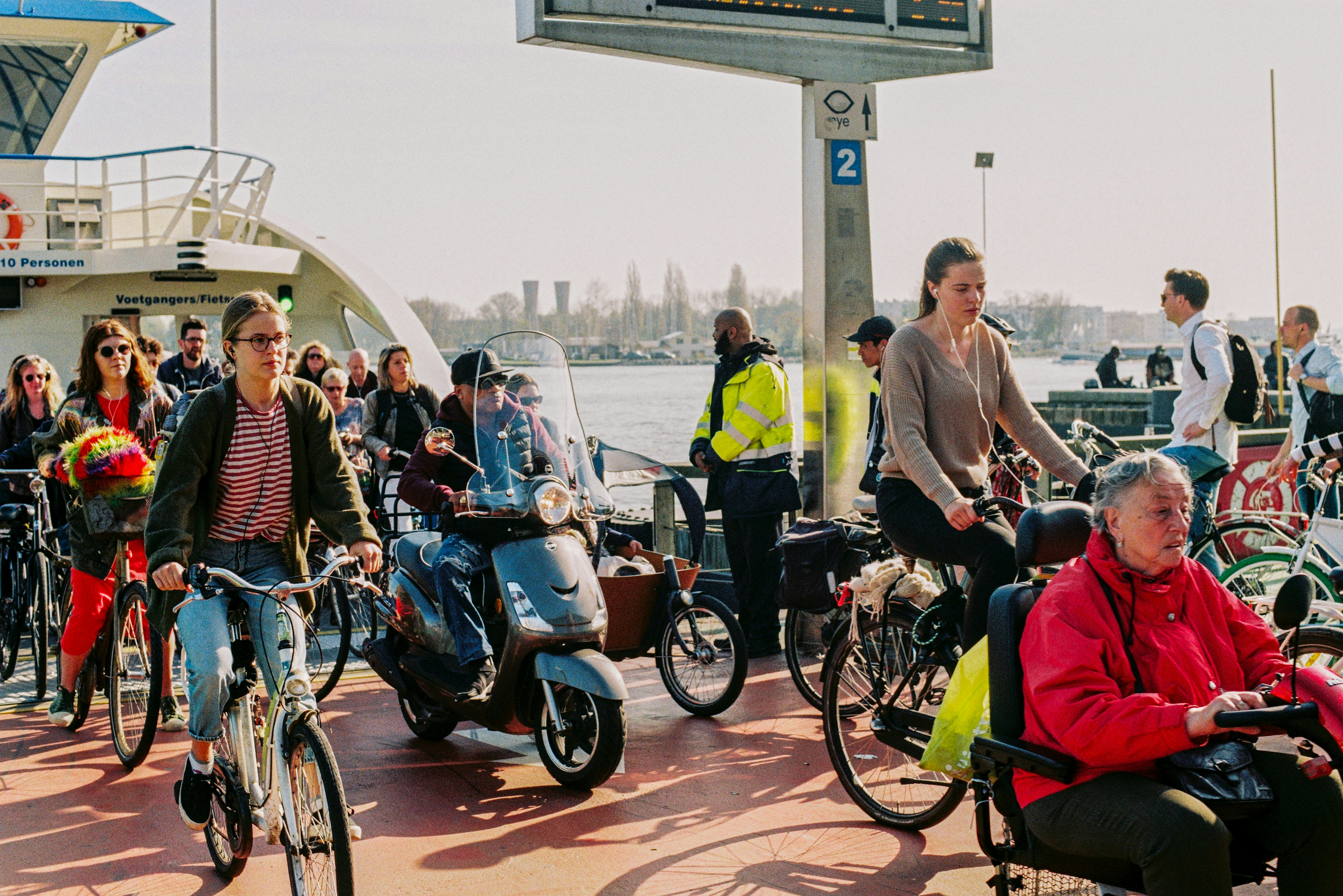cyclists and commuters getting out of a boat 