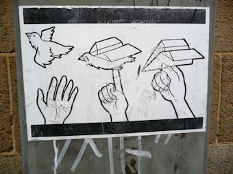 A black and white illustration depicting a sequence of a hand transforming into a paper airplane. The progression shows an open hand, a hand with a paper bird perched on the index finger, and finally, a hand holding a paper airplane ready to fly. The artwork is displayed on a textured surface.