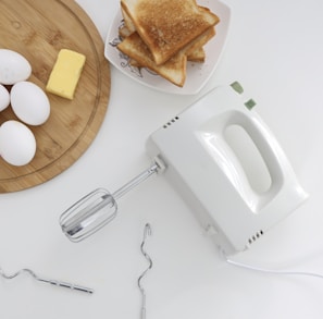 white apple earpods beside bread on white ceramic plate