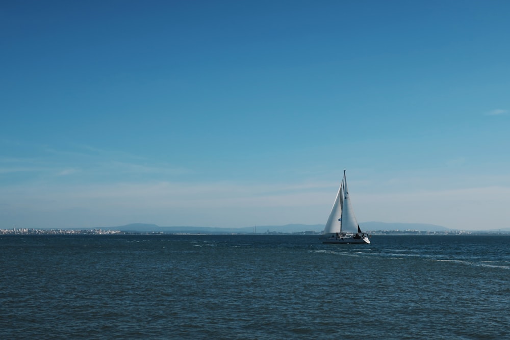 sailboat on sea under blue sky during daytime