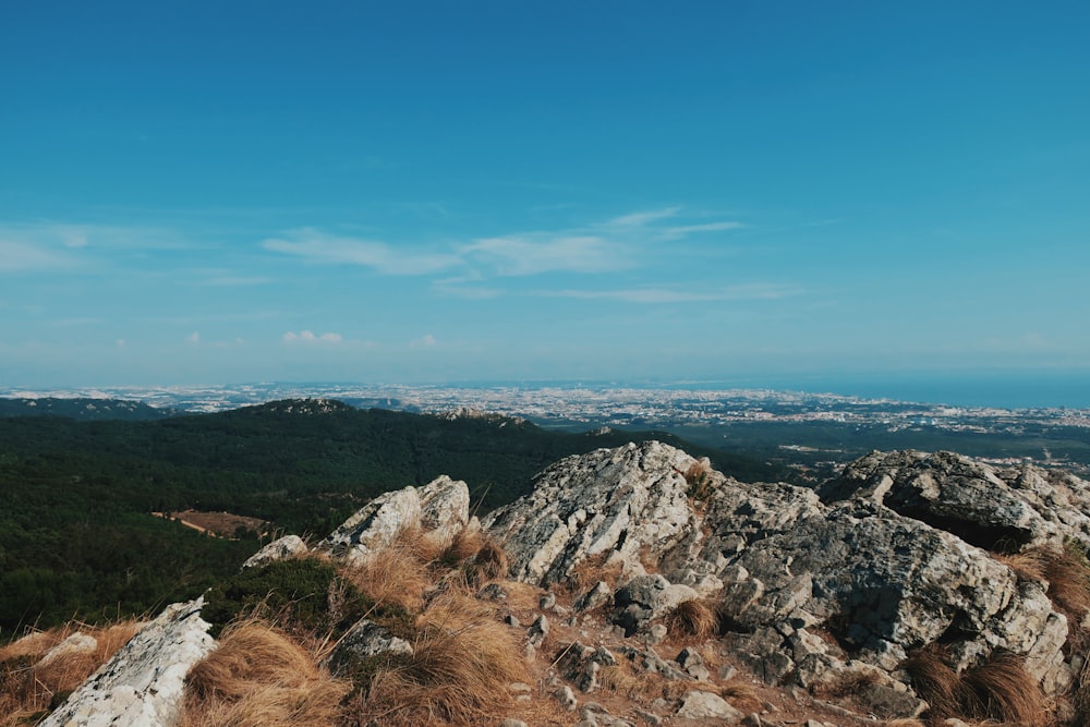 a view of a mountain with a blue sky in the background