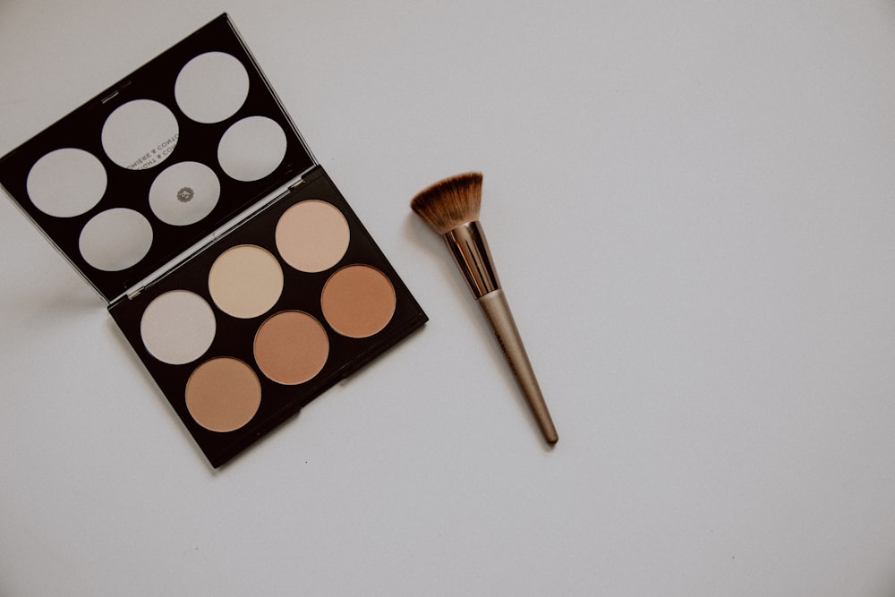 brown and white makeup brush