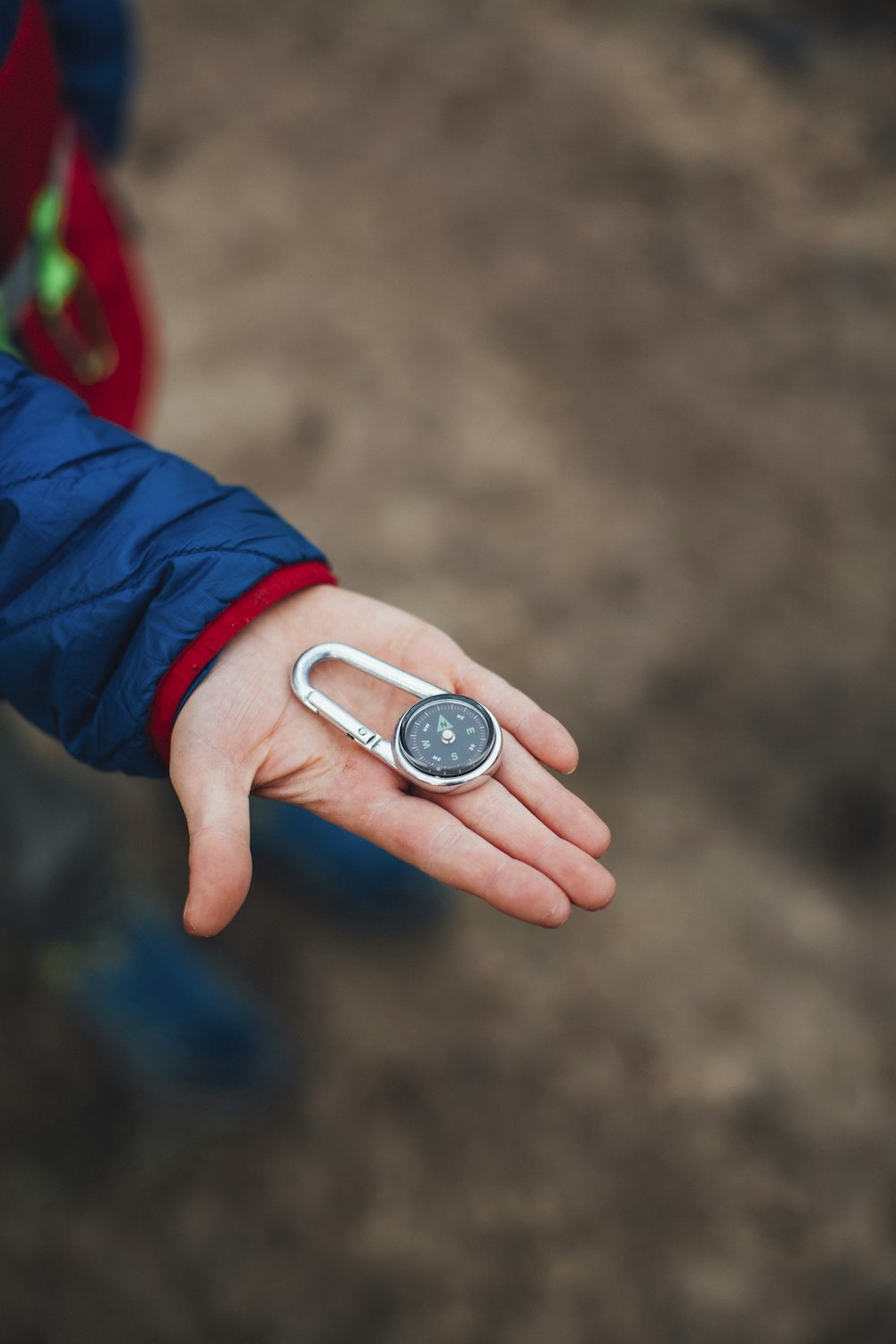 person holding silver and black round analog watch