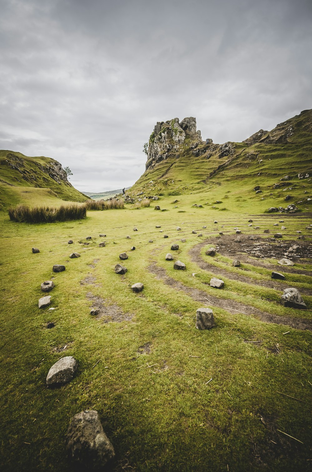 green grass field near mountain during daytime