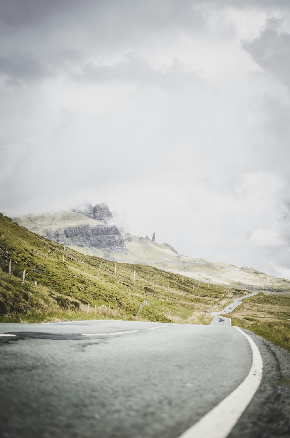 gray asphalt road near snow covered mountain during daytime