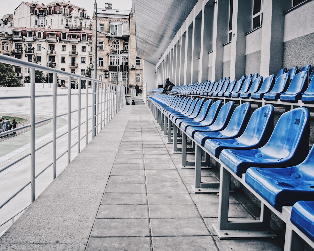blue and white metal benches on gray concrete pavement