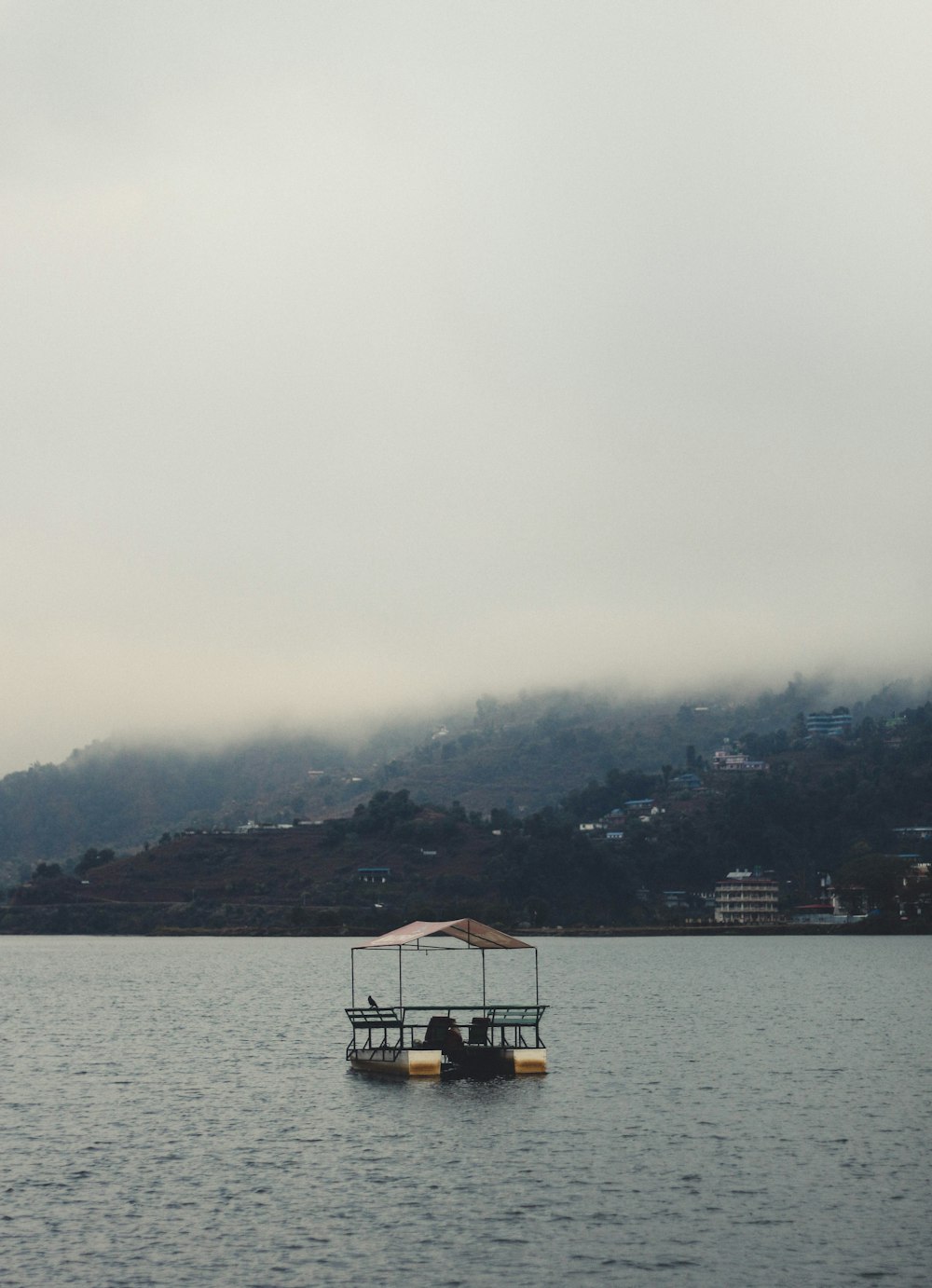 boat on water near mountain during daytime