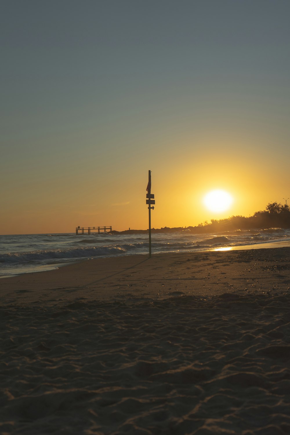 silhouette of people walking on beach during sunset