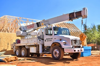 Crane truck in front of construction site