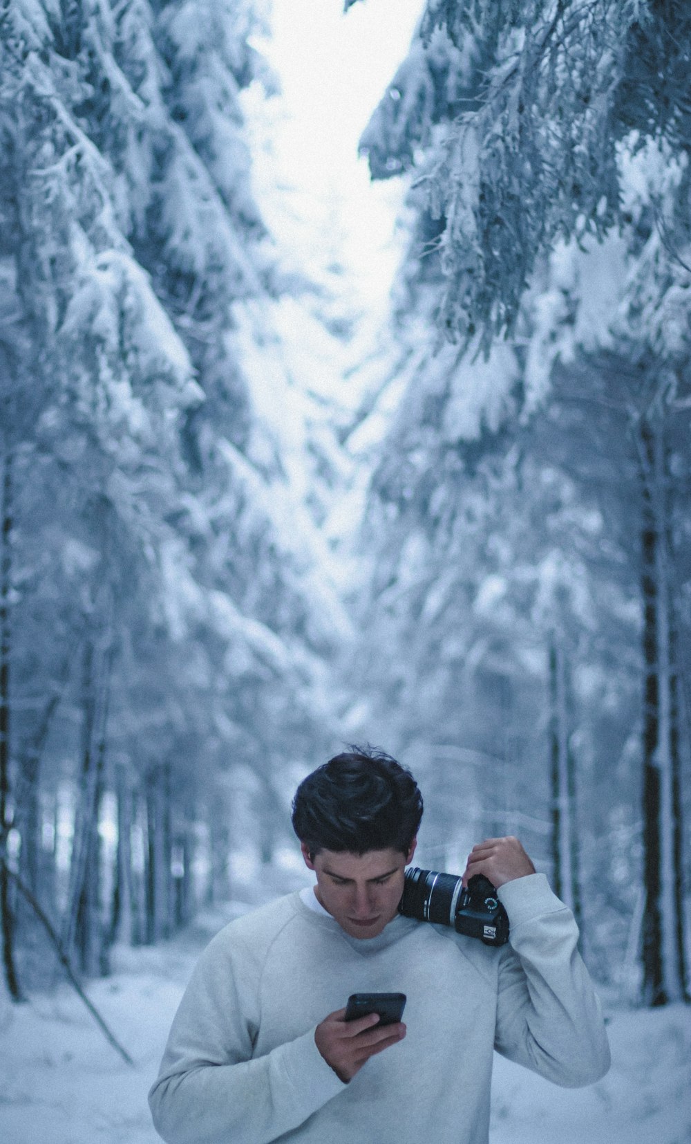 man in black jacket holding black dslr camera