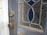 A close-up photo of a beautifully crafted custom exterior door with a curved glass panel.