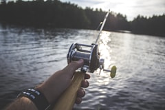 Baitcasting reel over sunlit water