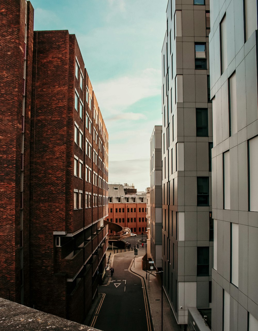 cars parked beside brown concrete building during daytime