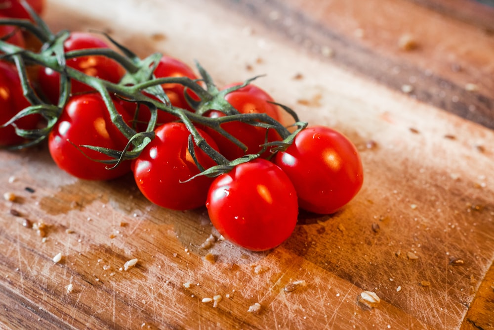 red tomatoes on brown wooden table