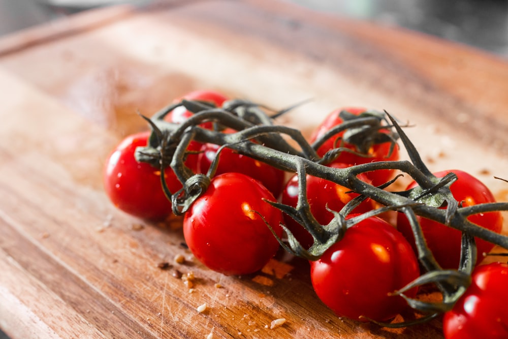 red cherry tomatoes on brown wooden table
