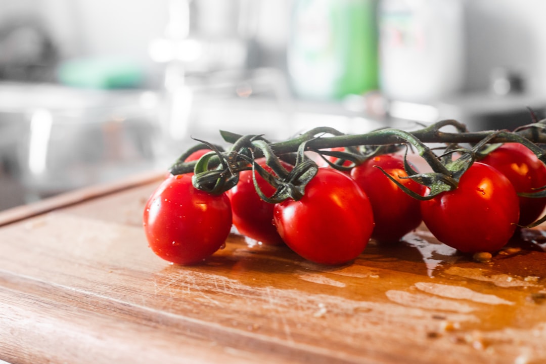 red tomato on brown wooden table