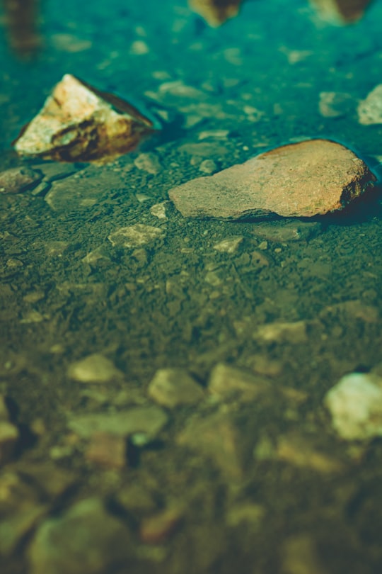 brown and white stone on water in Pnika Greece