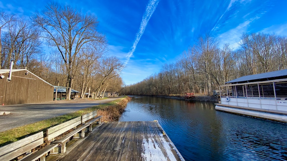 brown wooden dock near body of water during daytime