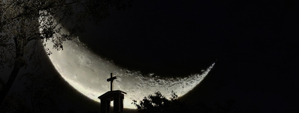 silhouette of cross under starry night