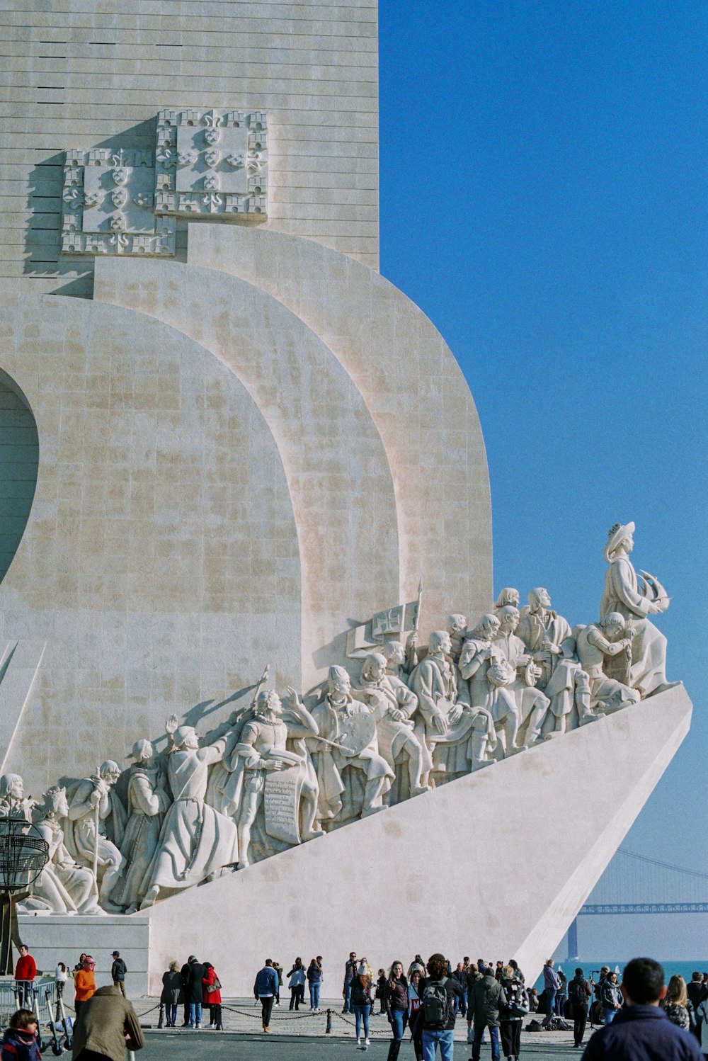 people sitting on white concrete bench during daytime