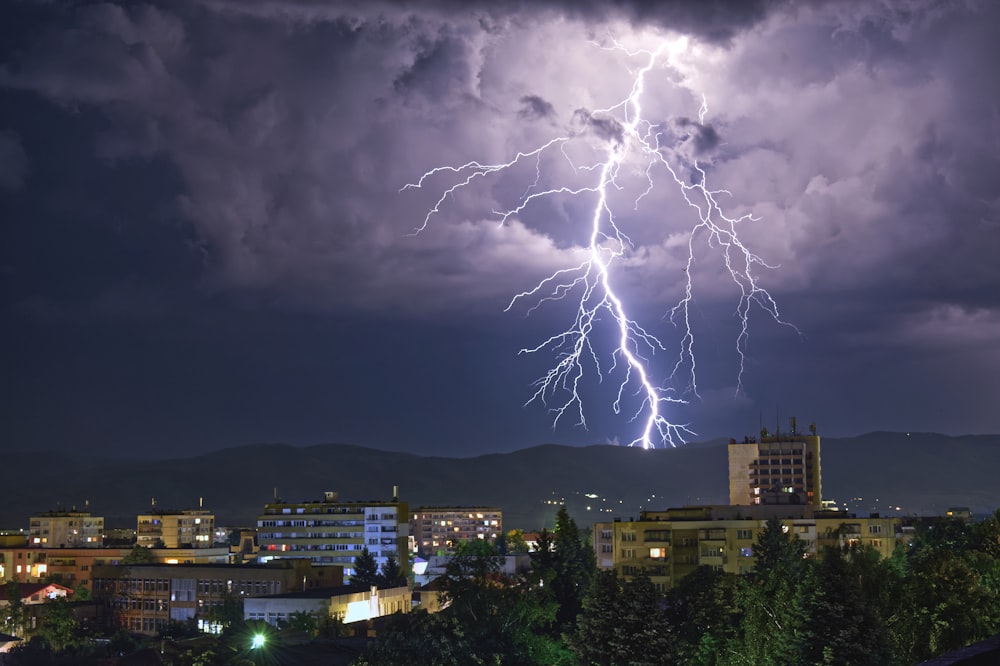 lightning UNK on city during night time