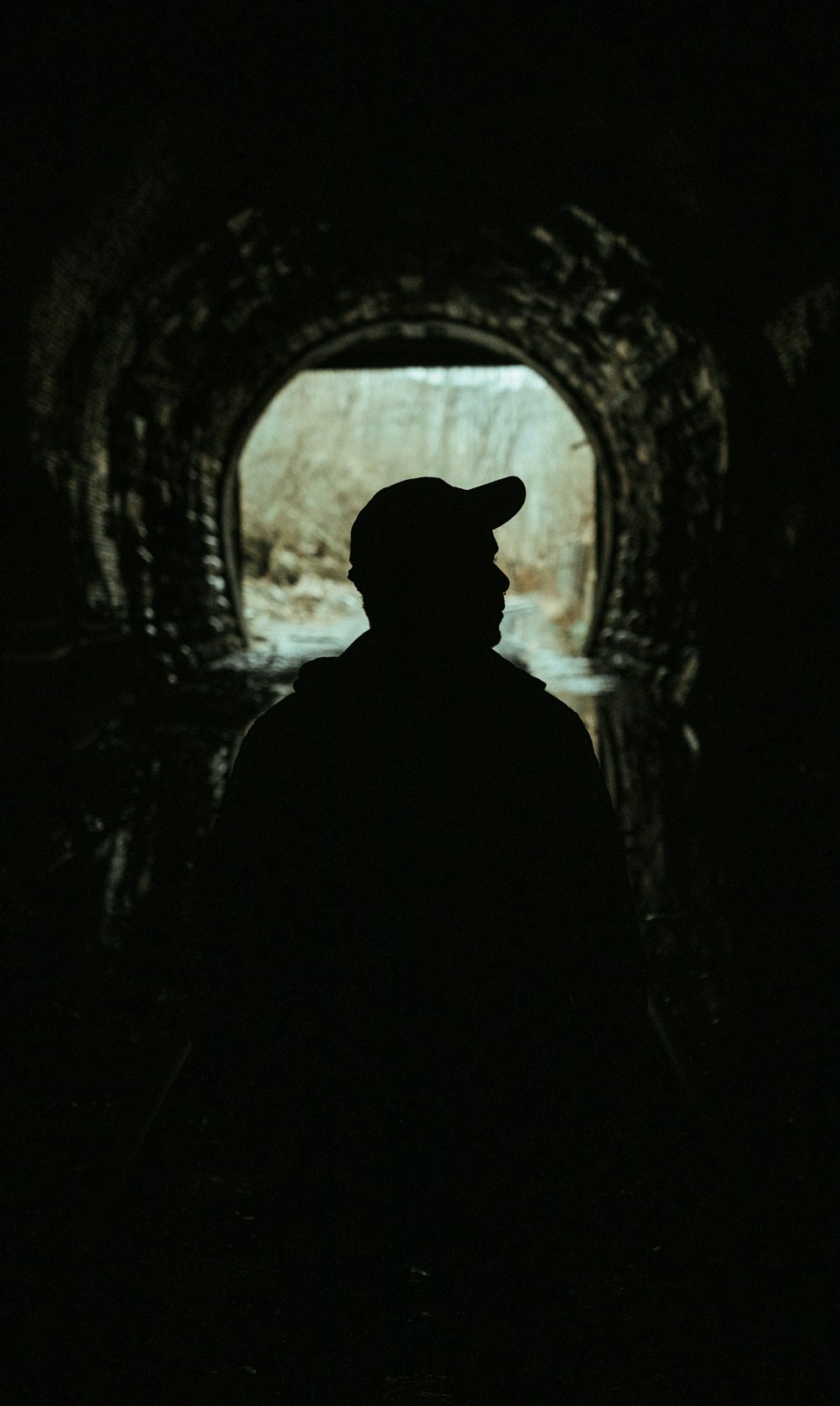 silhouette of man in tunnel