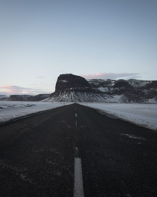 black asphalt road near snow covered mountain during daytime in Lómagnúpur Iceland