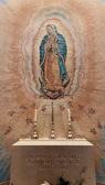 A vintage illustration of Saint Juan Diego holding the tilma with the Virgin of Guadalupe's image.