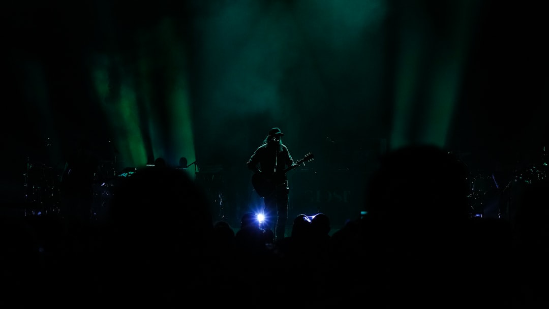 man playing guitar on stage