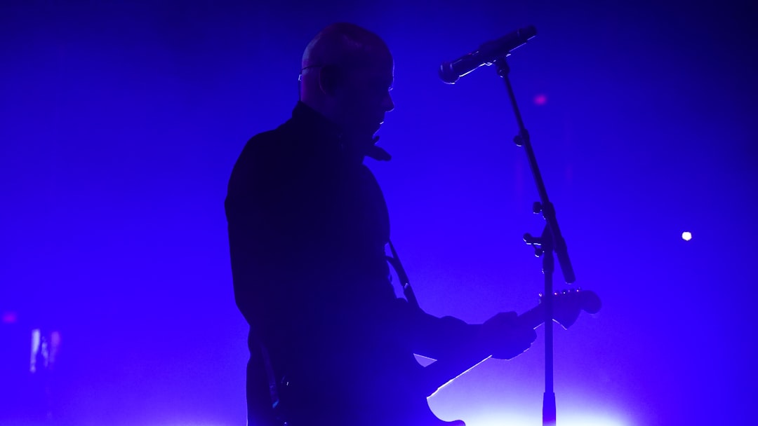 silhouette of man singing on stage