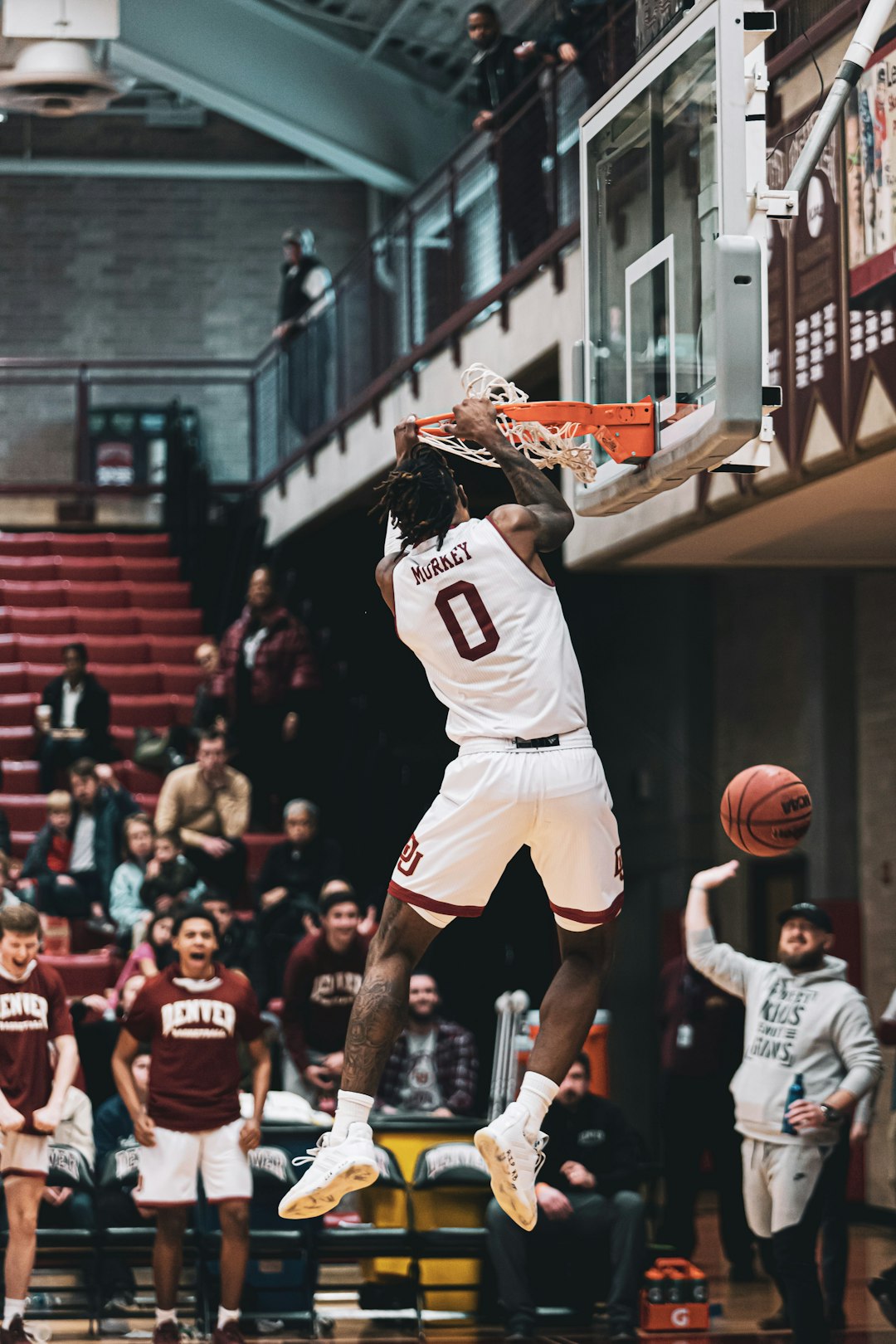 man in white jersey shirt playing basketball