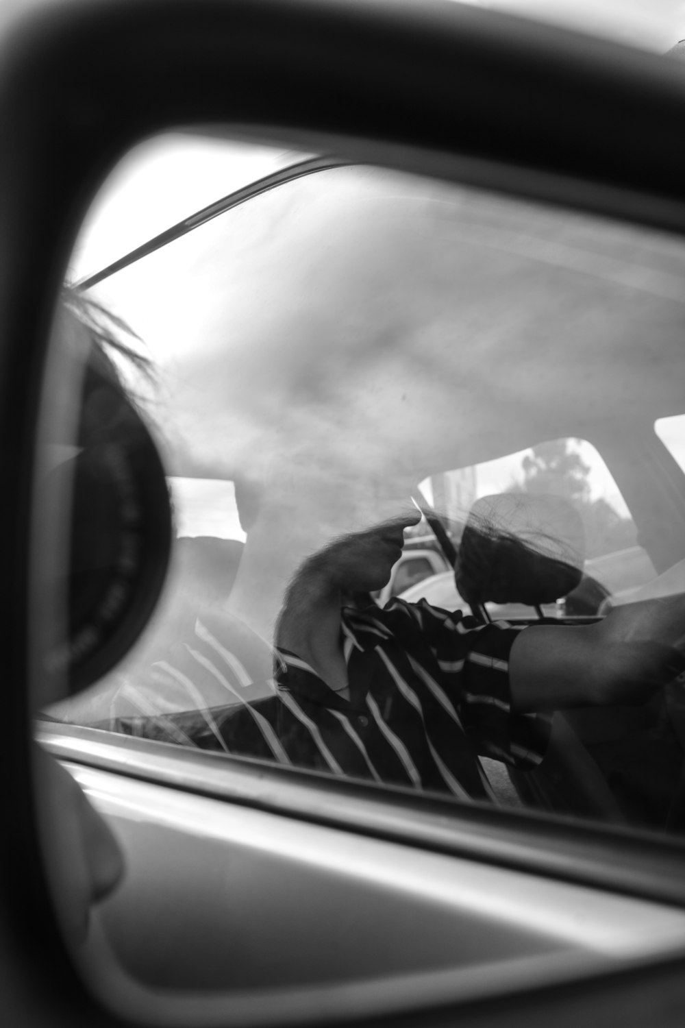 grayscale photo of man in car