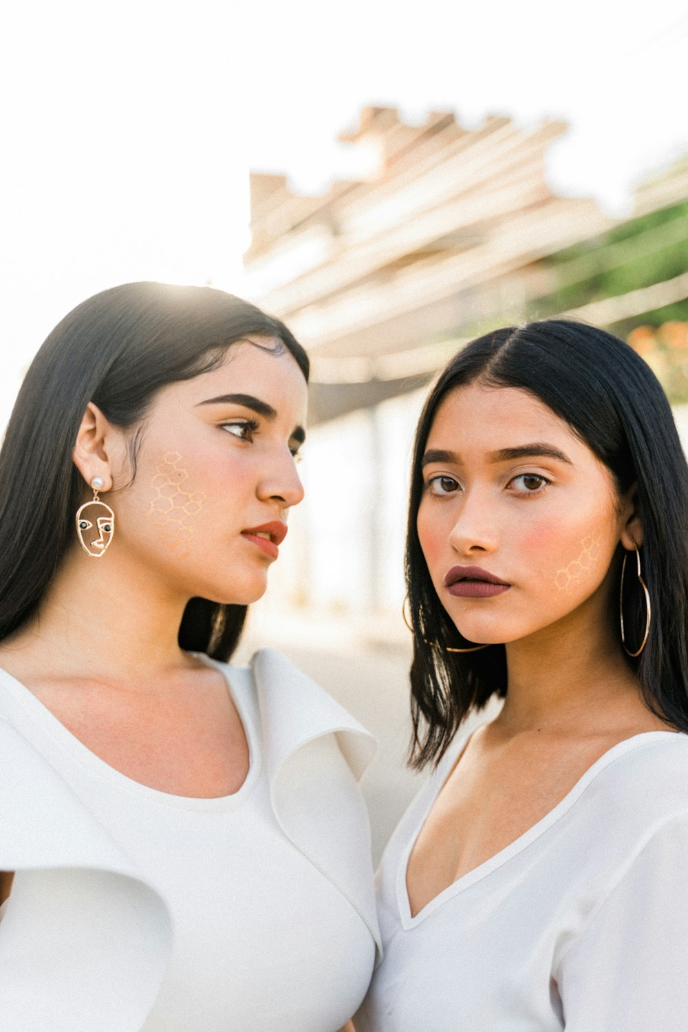 woman in white scoop neck shirt wearing silver earrings