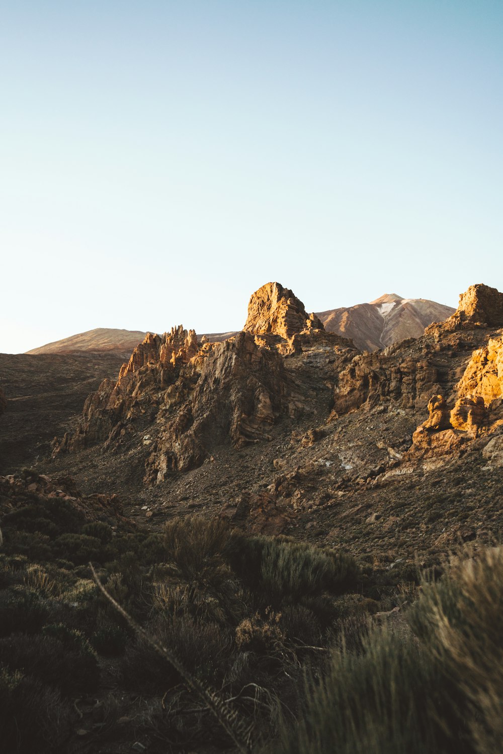 brown rocky mountain under blue sky during daytime