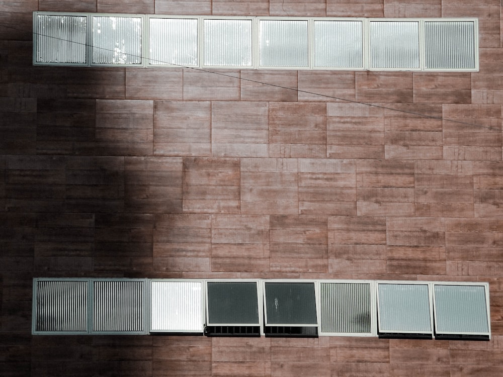 brown brick wall with white window