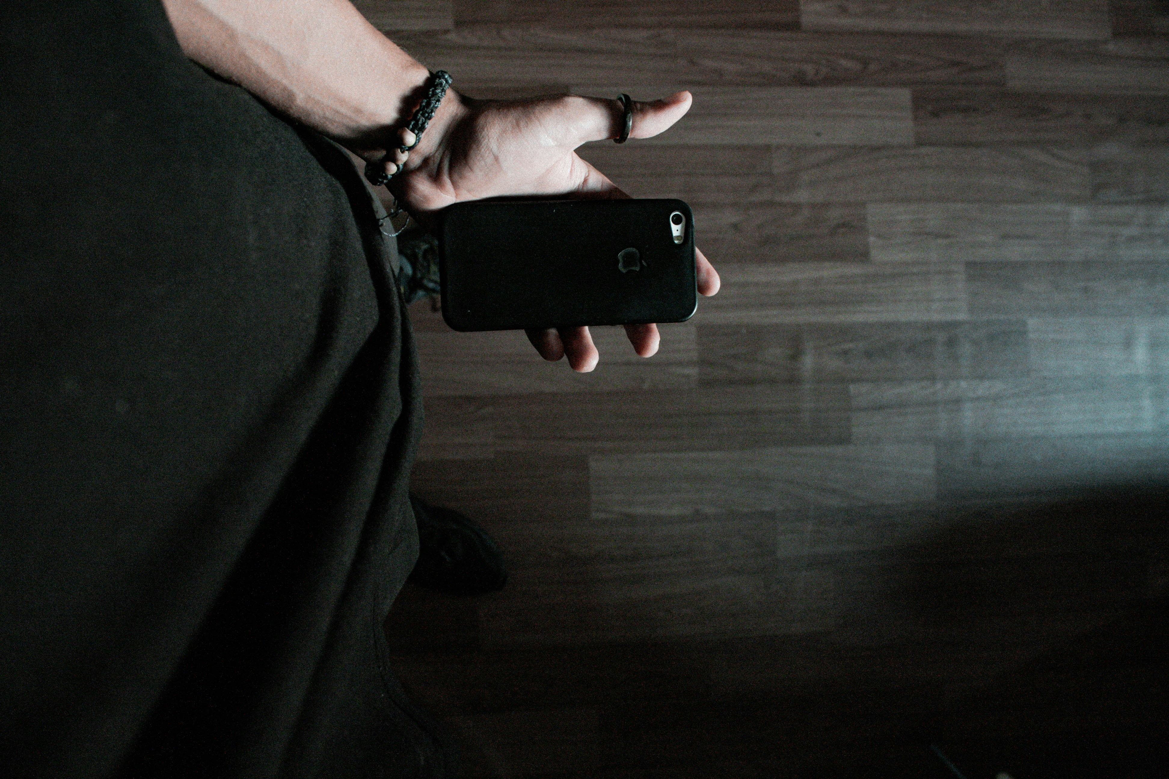 Person holding black iphone 5