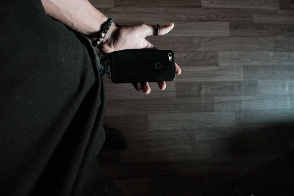 person holding black iphone 5