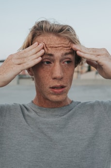 man in gray crew neck shirt with brown hair