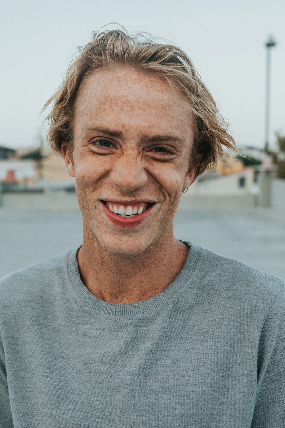 man in gray crew neck shirt smiling