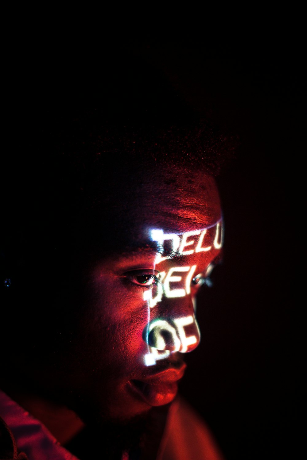 man with red and white light on face