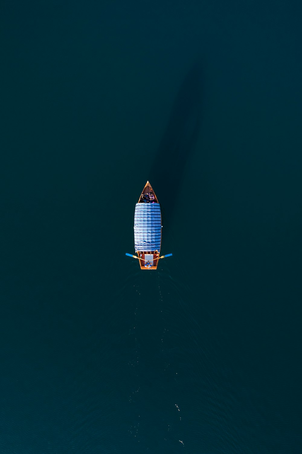 a small boat floating on top of a large body of water