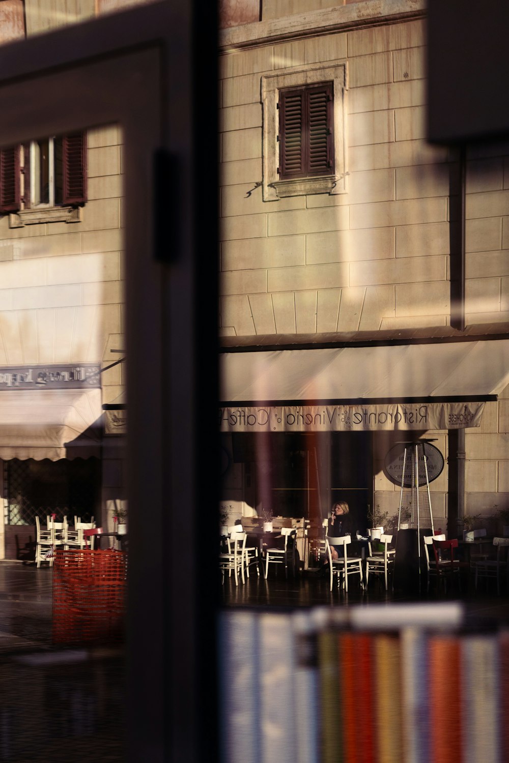 people sitting on chairs near table and glass window